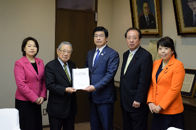 瀧澤議長から山本区長へへ報告書を提出するようす